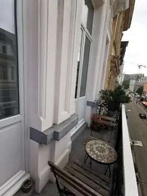 a balcony with a bench and a table on a building at B&B La Ducale in Ghent