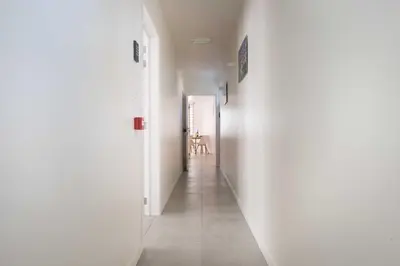 a hallway with white walls and a room with a table at Studio Brussels Airport - South in Zaventem