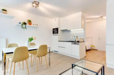 a kitchen and dining room with a table and chairs at Royal Arts-Loi Studio in Brussels