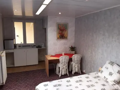 a room with a table and chairs and a bed at CASA DI MARCO in Antwerp