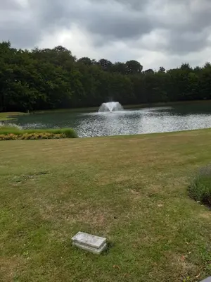a pond with a fountain in the middle of a park at CASA DI MARCO in Antwerp