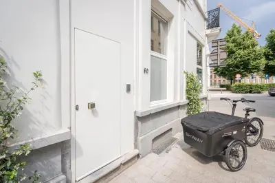 a scooter parked outside of a building with a door at SHWAY - The Red With Pearls in Antwerp