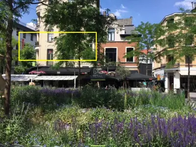 a yellow rectangle in the middle of a garden with flowers at Theodore Residence in the Heart of Antwerp in Antwerp