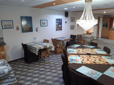 a dining room with tables and chairs and a chandelier at casa di Claudia in Antwerp
