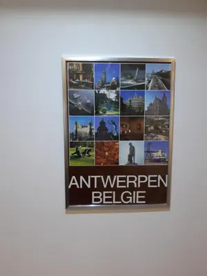 a framed picture on a wall with an american believe sign at casa di Gino in Antwerp