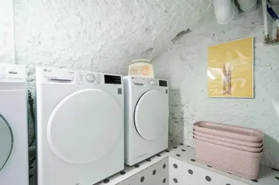 a white washer and dryer in a bathroom at SHWAY - The Red Monkey in Antwerp