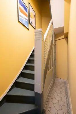 a hallway with stairs in a house at SHWAY - The Blue Parrot in Antwerp