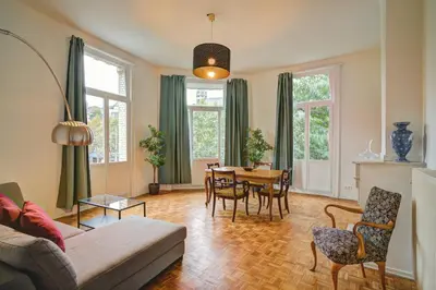 a living room with a table and chairs at The National Lodge in Antwerp