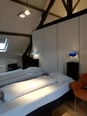 a bedroom with two beds and a blue lamp at NUVOLA VILLA in Zottegem