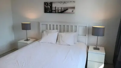a bedroom with a white bed with two lamps at 19 Brussels Expo in Wemmel
