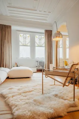a living room with a table and a rug at Huis Hector Mechiels ROOM in Sint-Niklaas