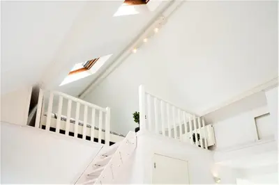 a white staircase in a home with white ceilings at Beautiful Cozy Apartments in the Heart of Antwerp in Antwerp