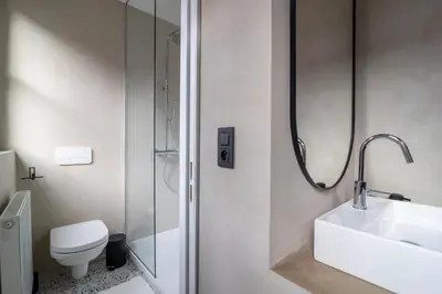 a bathroom with a sink and a toilet and a shower at Charming House in Le Sablon in Brussels