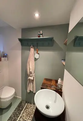 a bathroom with a white toilet and a sink at Studio Dageraad in Antwerp