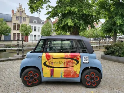 a small car is parked on a street at Huis ALNA 2 in Mechelen