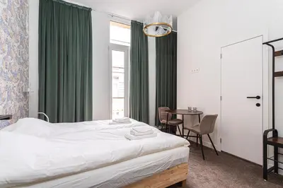 a bedroom with a bed and a table with chairs at Studio Anvers in Antwerp