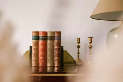 three books sitting on a shelf next to a lamp at Unbeatable Location Explore Ghent on Foot! in Ghent